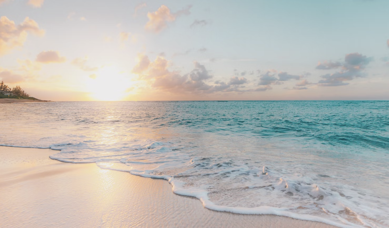 A stunning aerial view of a pristine beach with turquoise water and white sand, perfectly capturing the essence of a seaside escape.