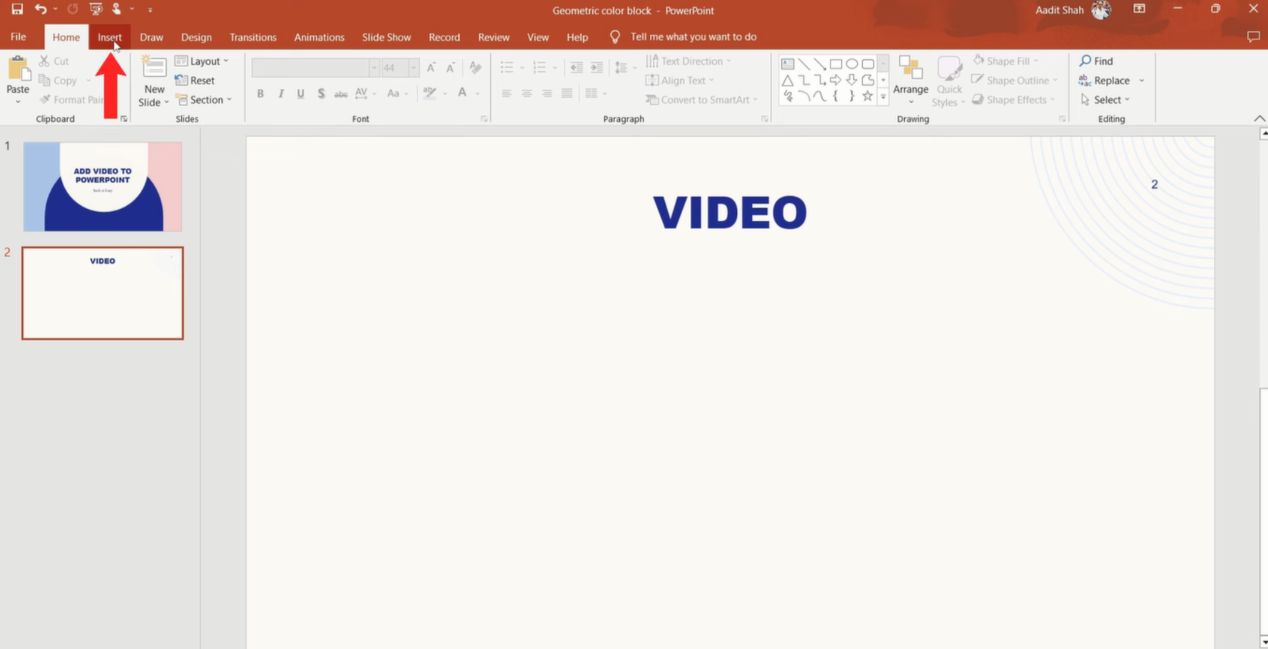 Accessing the insert tab to add a YouTube video to PowerPoint