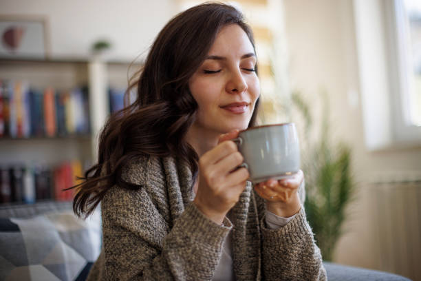A person enjoying morning coffee in a cozy kitchen or cafe