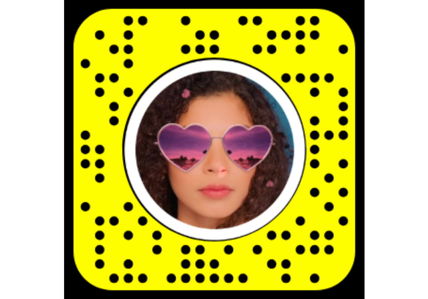 Selfie with oversized sunglasses and party hat via Snapchat filters