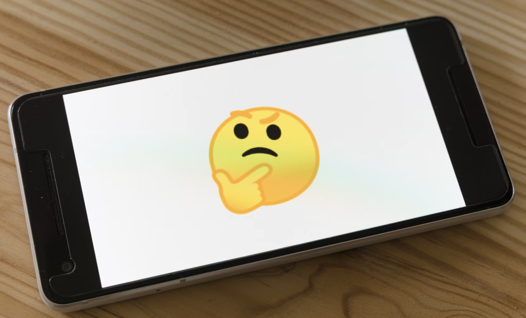A person smiling while reading a message on their phone