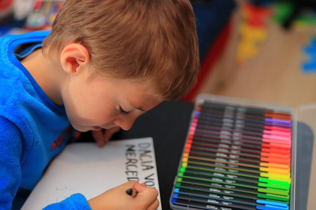 A child writing on a colorful Christmas list template