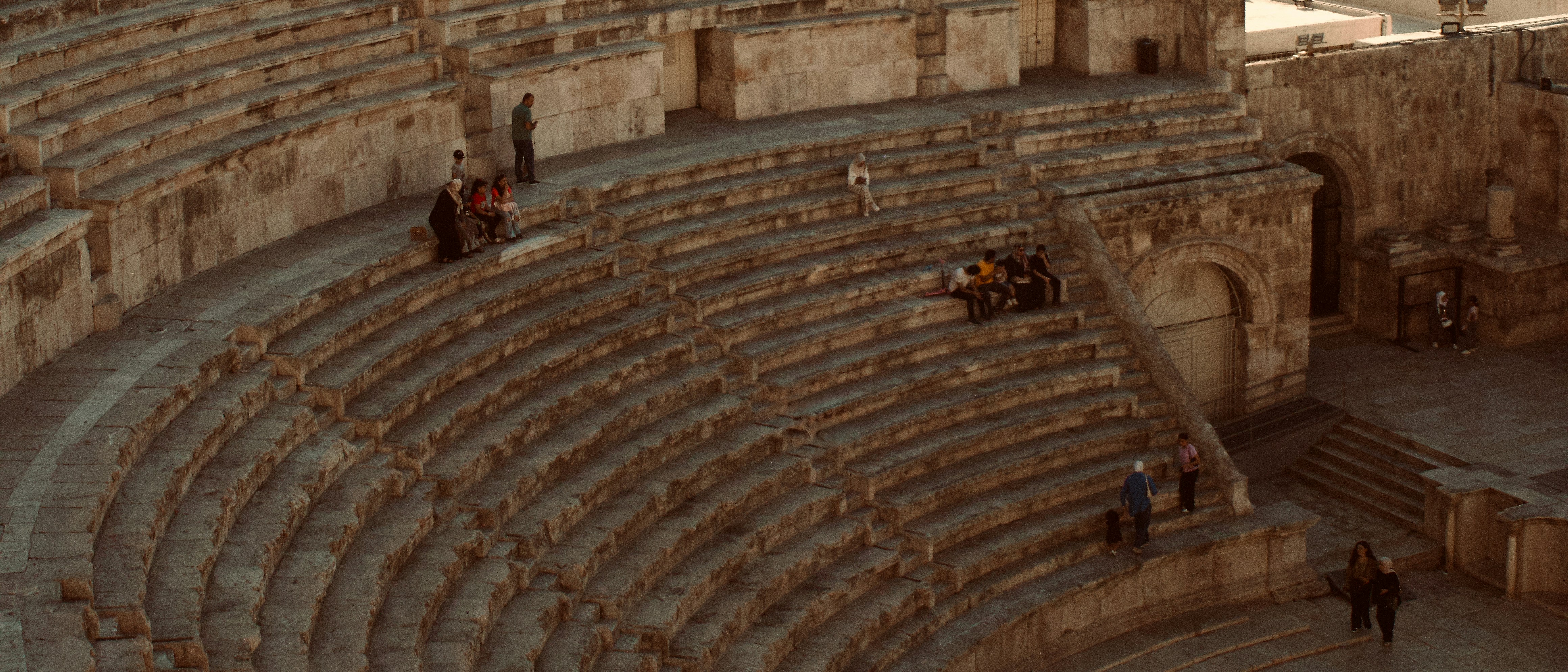 A powerful and inspiring image representing the spirit of "The Man in the Arena." It could show a lone figure in a vast arena, ready to face a challenge, with a spotlight on them. The overall tone should be one of courage, determination, and resilience.