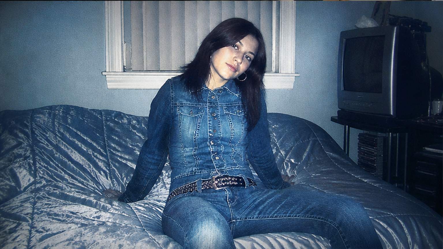 Natural studio portrait of a fictional adult 2000s photo editor
