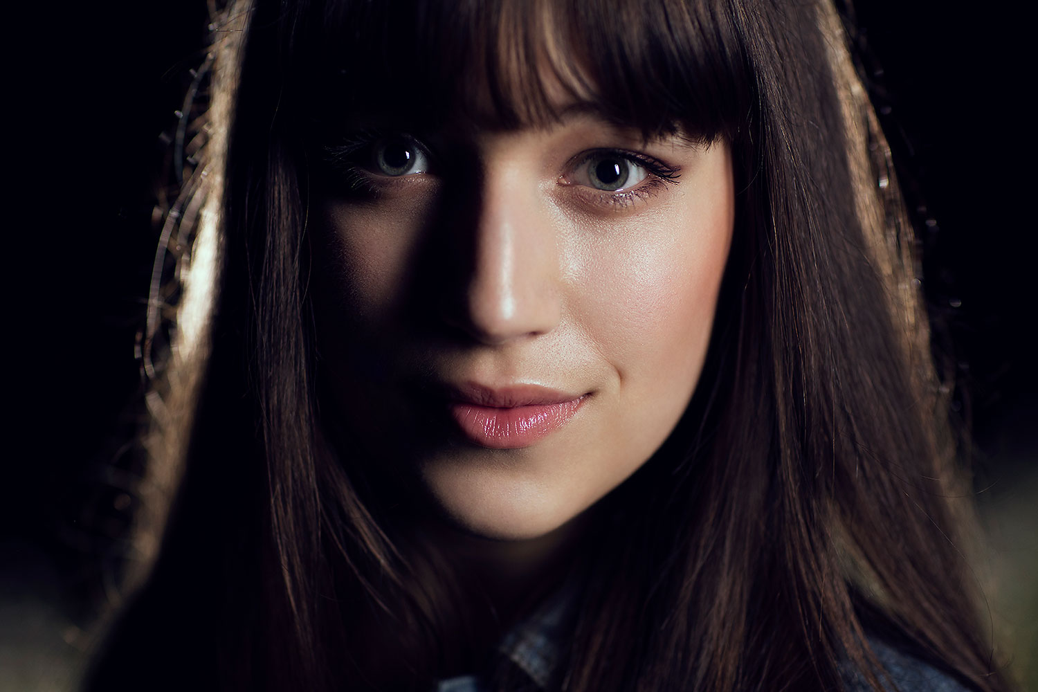 Low-key portrait with Rembrandt triangle on cheek and dark shadows