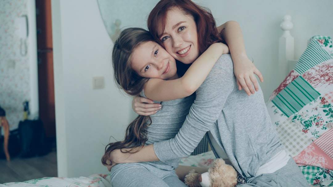 a mother and daughter smiling and hugging, conveying a sense of warmth and love