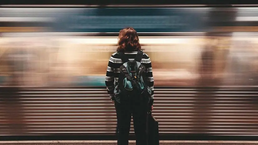 Subject movement film transitions with a train moving past a person