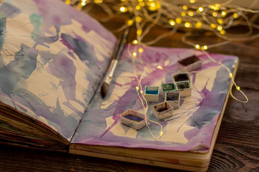 Overhead of Christmas coloring pages with markers and hot cocoa