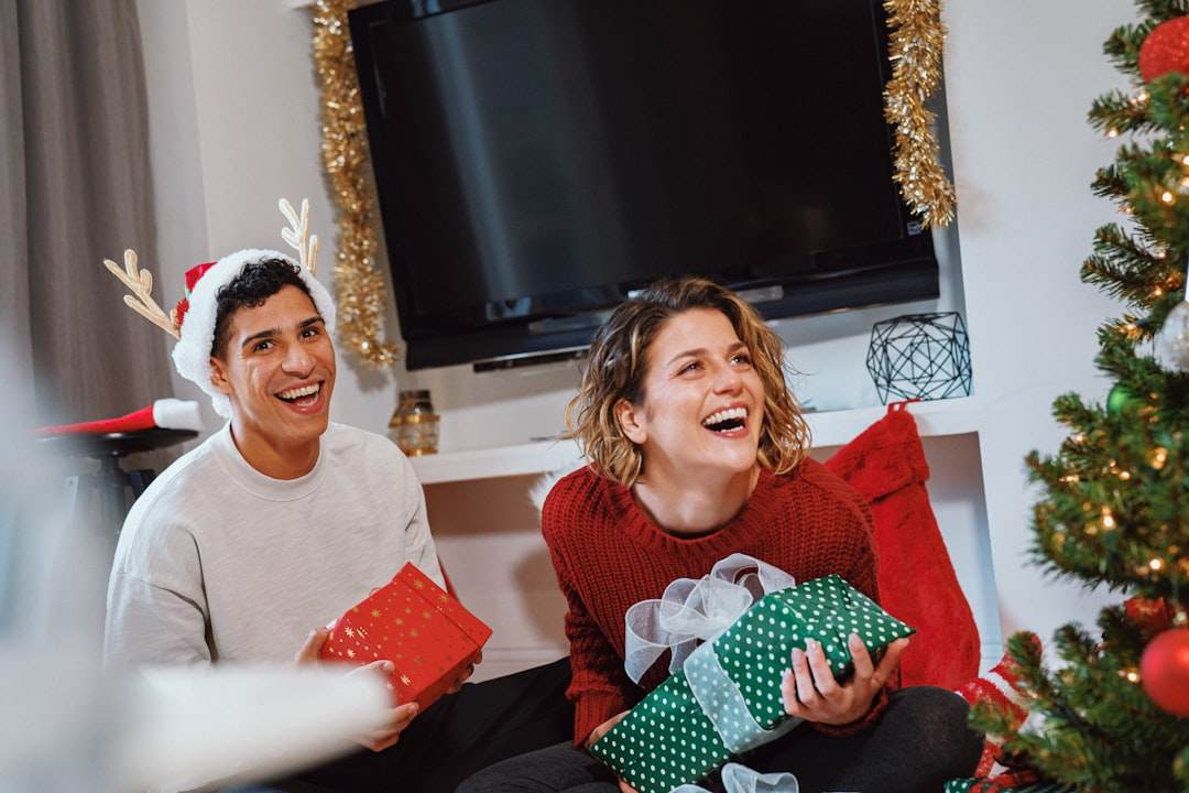A candid photo of a family laughing together while wearing ugly Christmas sweaters