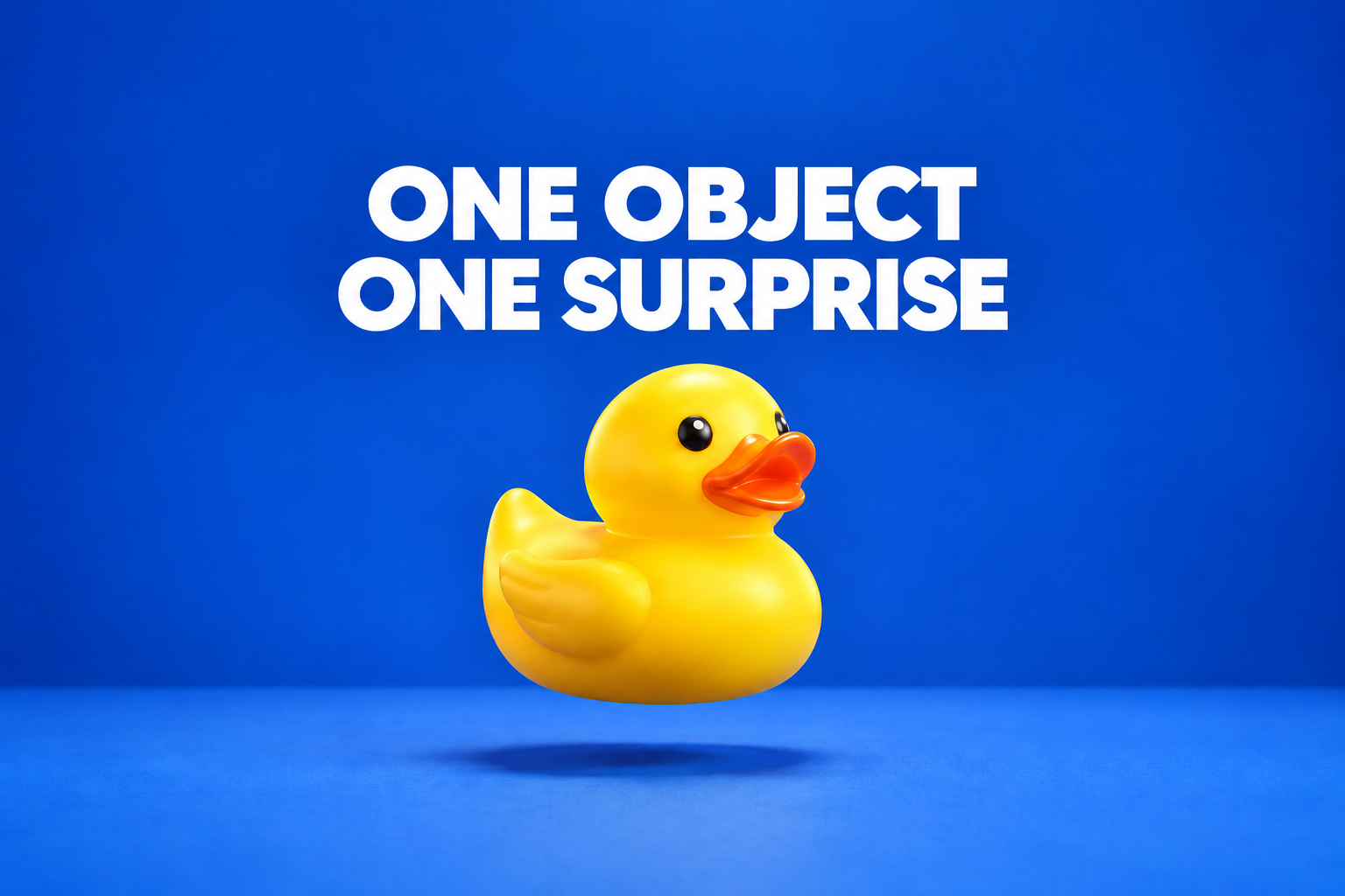A yellow rubber duck floats above a blue table beneath the title One Object One Surprise