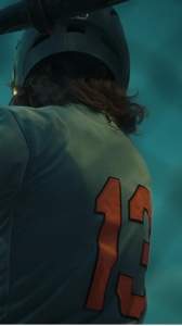 Back-view baseball player in a cinematic teal-lit portrait for styling exploration