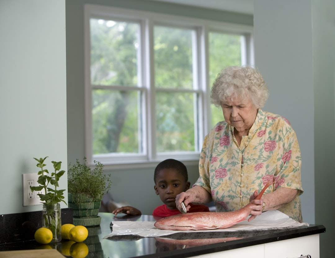 A grandmother and grandchild baking together.