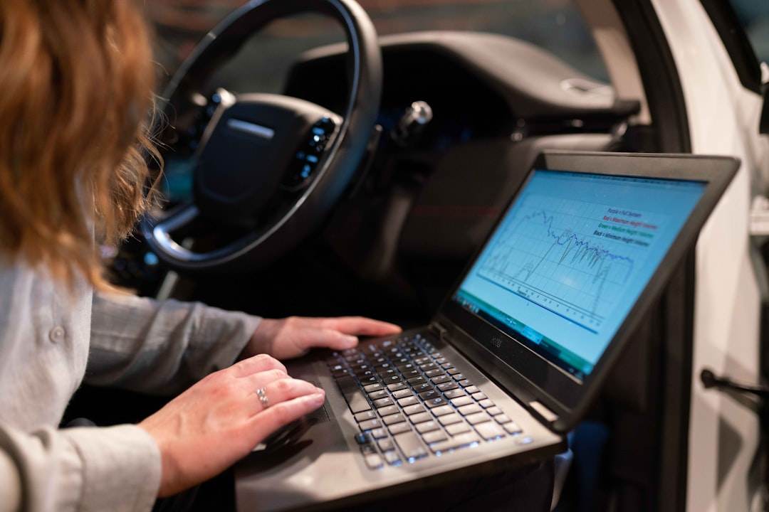 A person is reviewing their car insurance policy on a laptop.