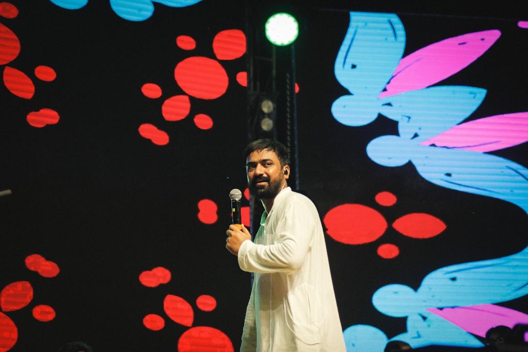Singer on stage with lyric subtitles in cinematic style