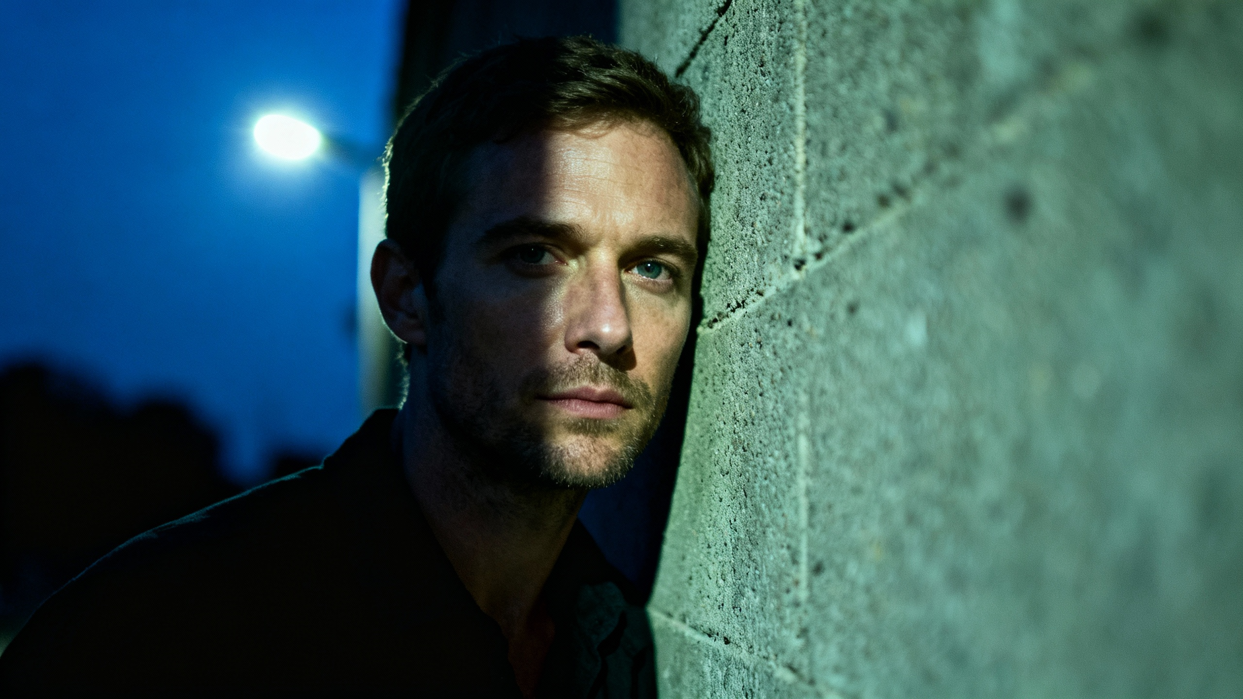 Man leaning against a wall