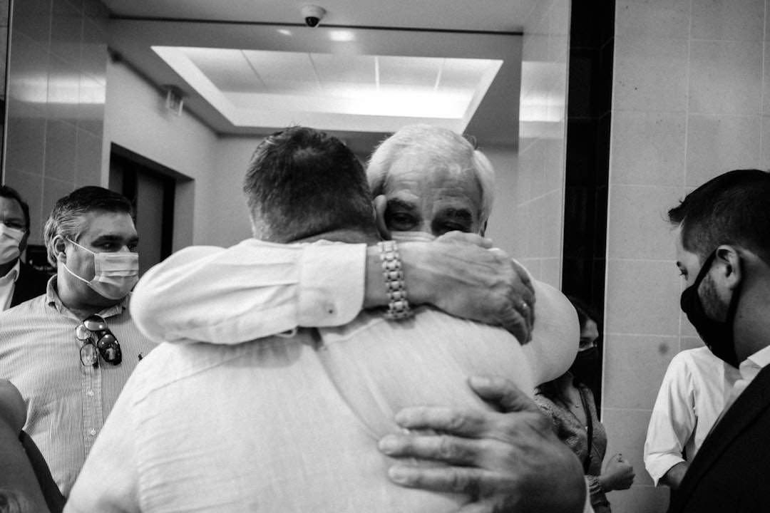 A touching moment between two brothers, perhaps a hug or a shared memory.
