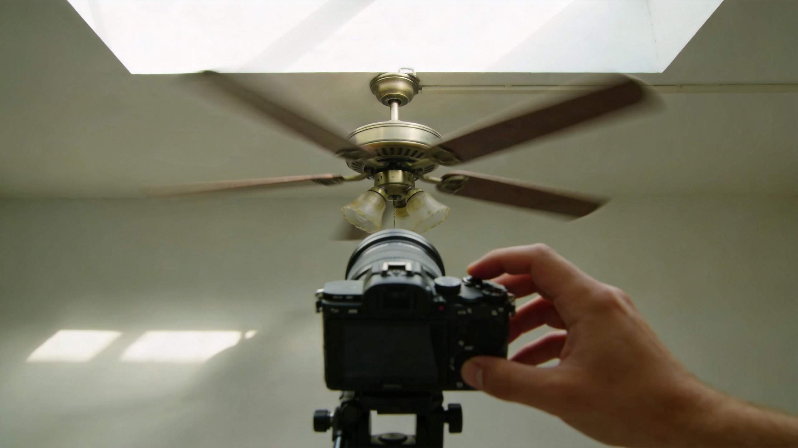 Camera pointed at a spinning ceiling fan, with blurred blades showing rolling shutter distortion