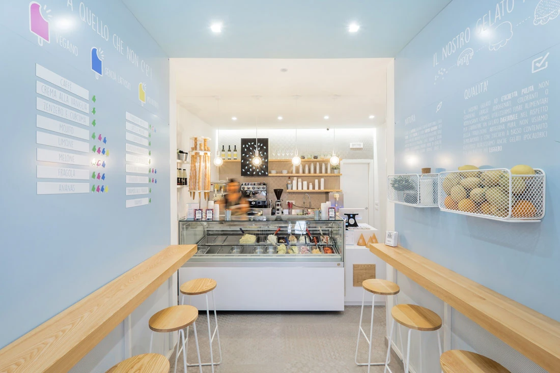 Minimalist ice cream shop with white walls and light wood