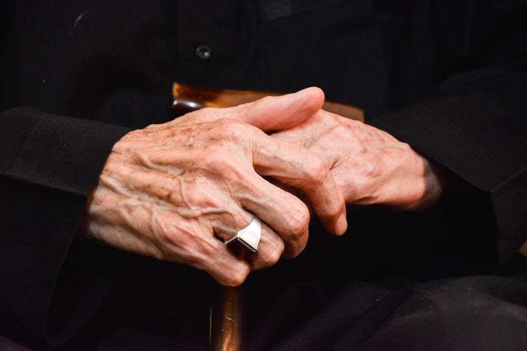 a simple, elegant image of two hands, one older and one younger, intertwined