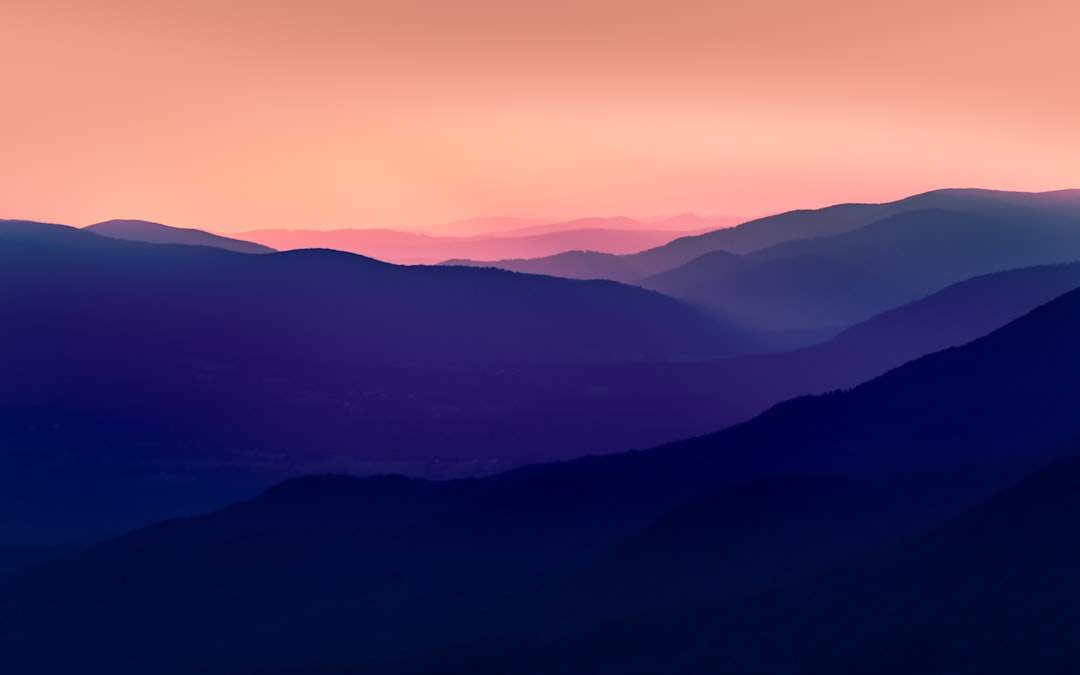 A beautiful mountain landscape at sunrise with a landscape filter applied, making the colors of the sky and mountains more vibrant.