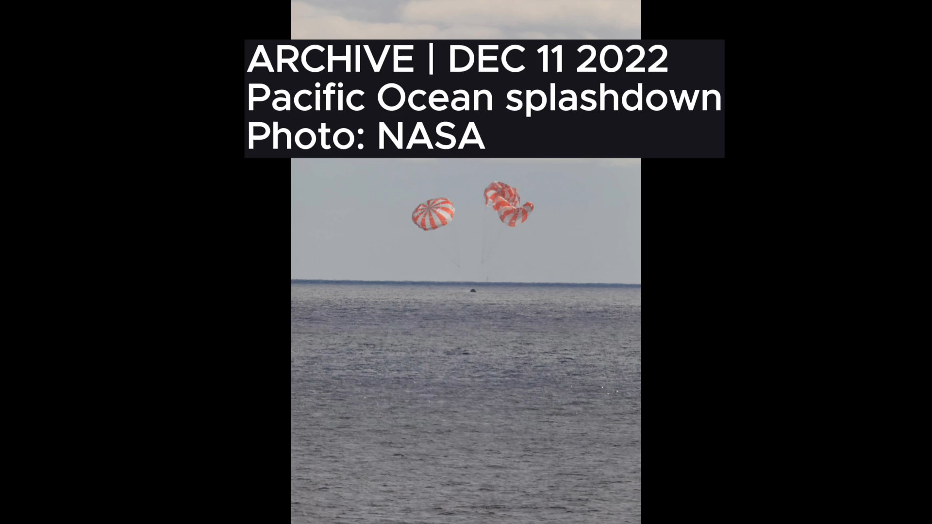 The exported descent frame preserves the parachutes and places the archive label above them