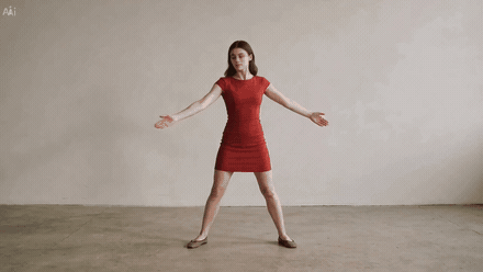 Woman in a red dress performs a Latin dance sequence animated from a single photo.