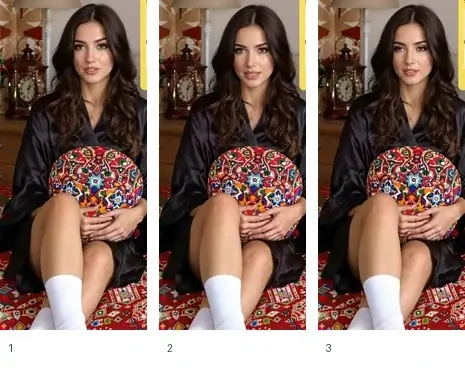 Una donna in una veste nera tiene un cuscino colorato mentre è seduta su un tappeto decorato.