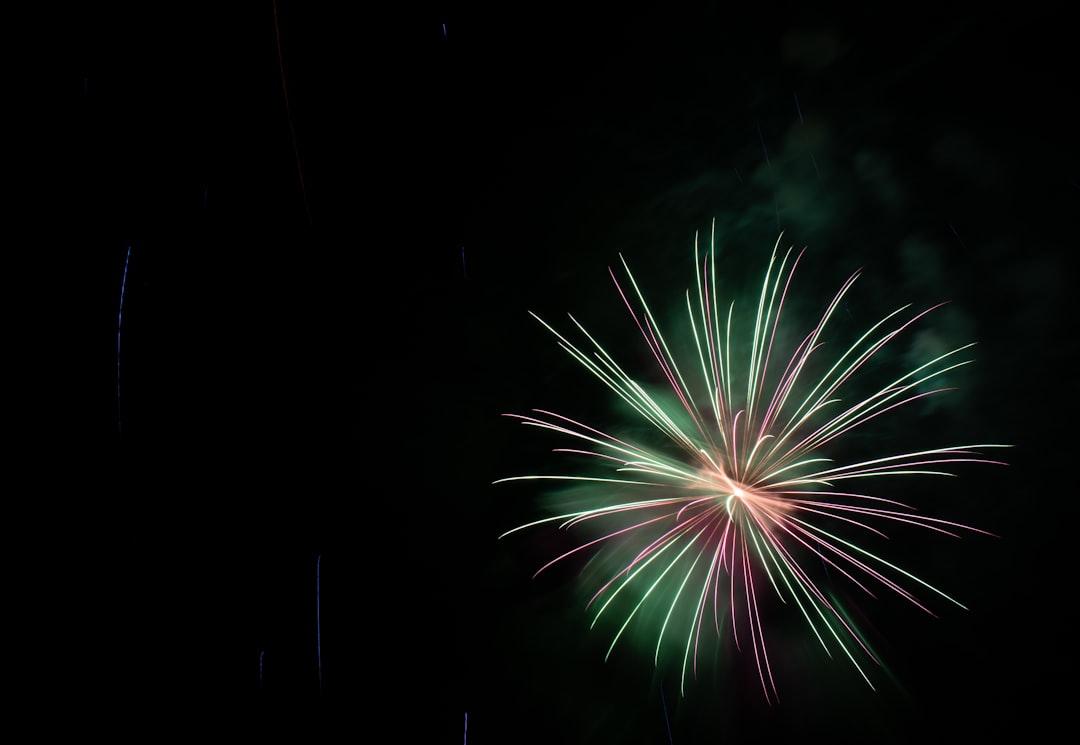 Wide fireworks burst with center logo reveal