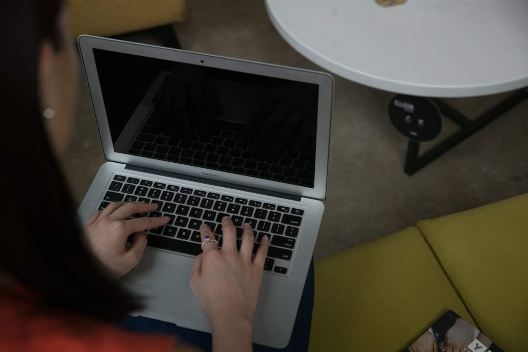 Person editing a video transcript on a laptop with notepad and headphones