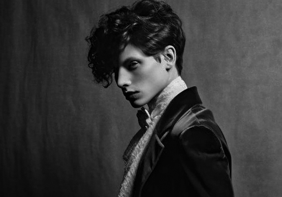 Studio portrait with strong Rembrandt lighting and deep shadows