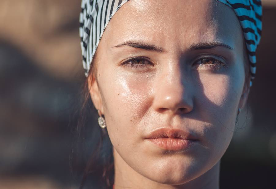 Outdoor portrait showing natural Rembrandt triangle formed by sunlight