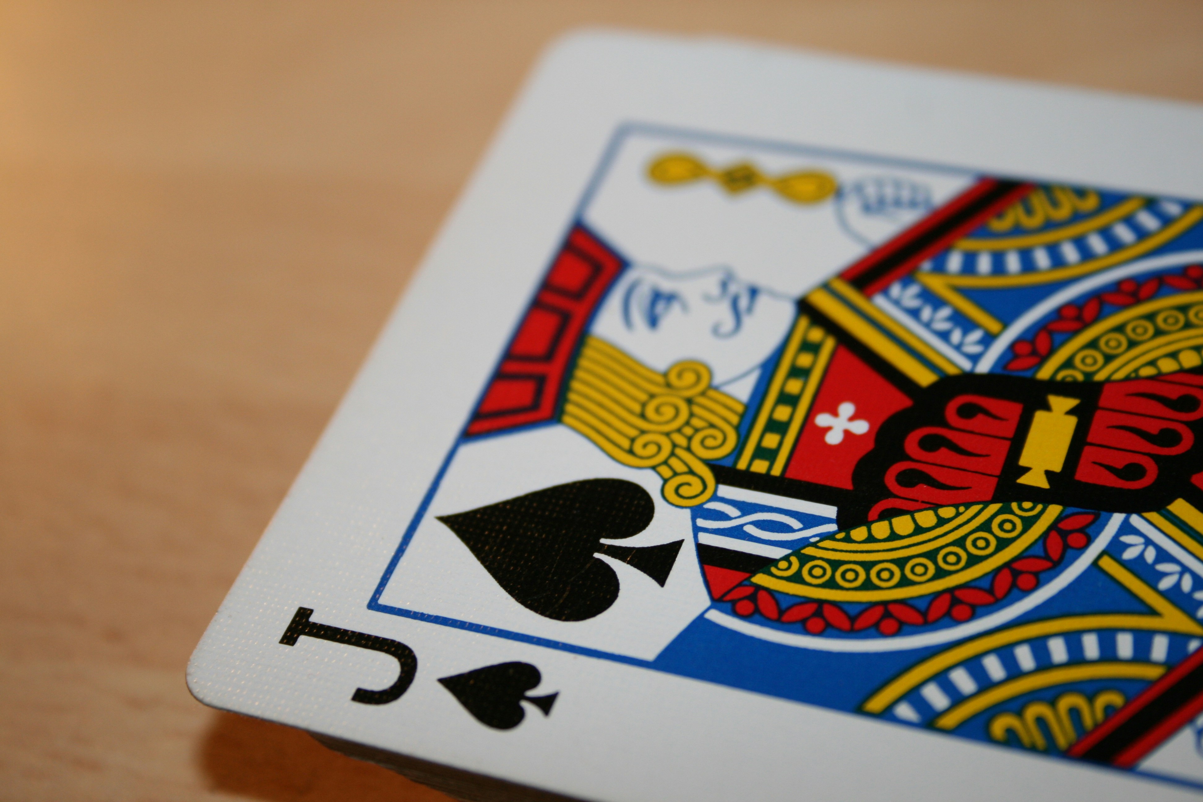 A close up image of a deck of playing cards with the Jack of Spades at the face