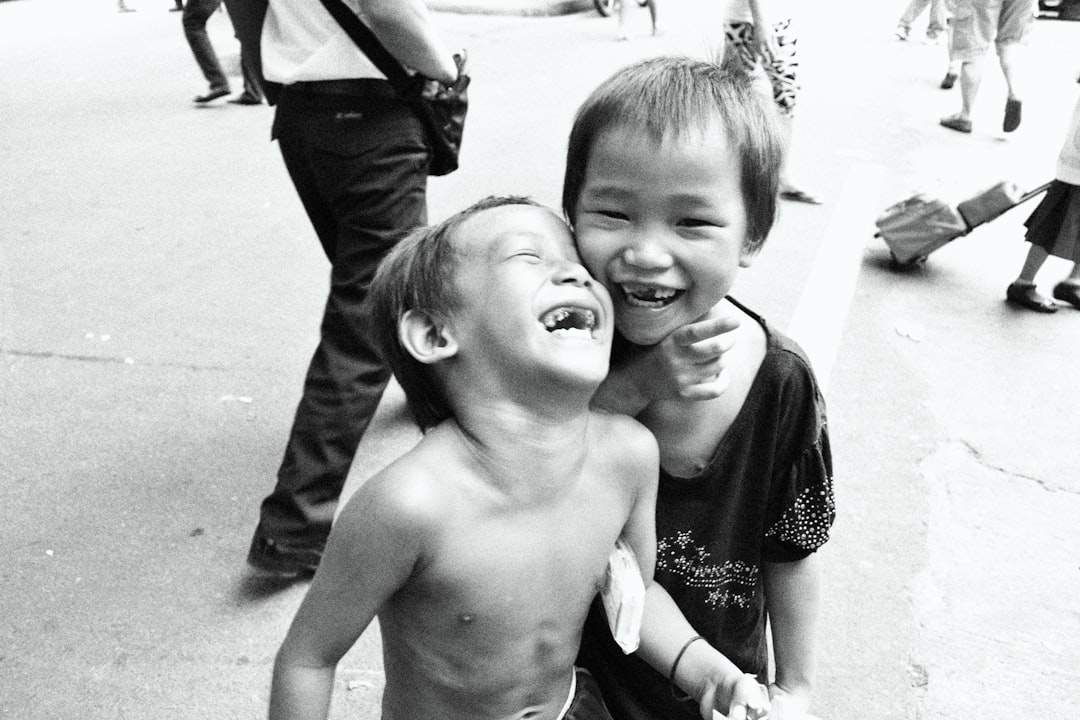 Two friends laughing and hugging.