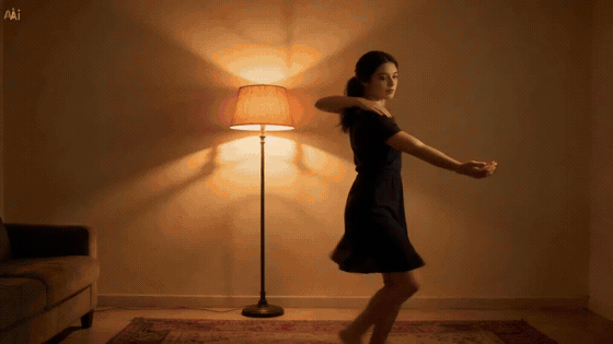 Woman dancing in a dim room beside a glowing floor lamp and couch