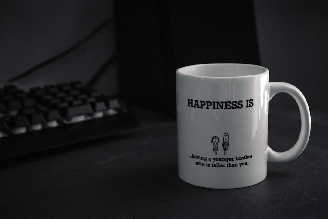 A cup of coffee with a smiley face on a desk