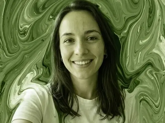 Smiling woman in a white T-shirt against a green marbled fluid art background