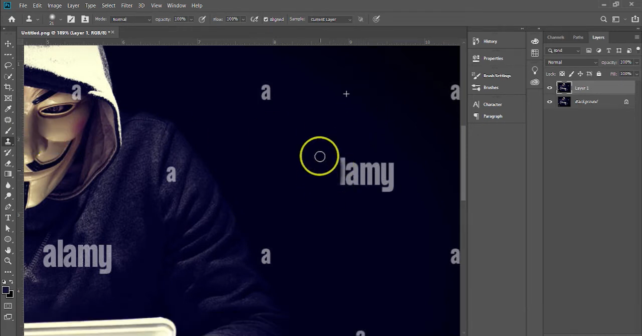 Hold Alt and click on a clean area near the watermark