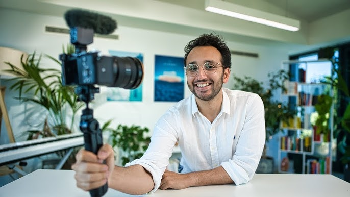 Vlogger speaking confidently in front of a camera