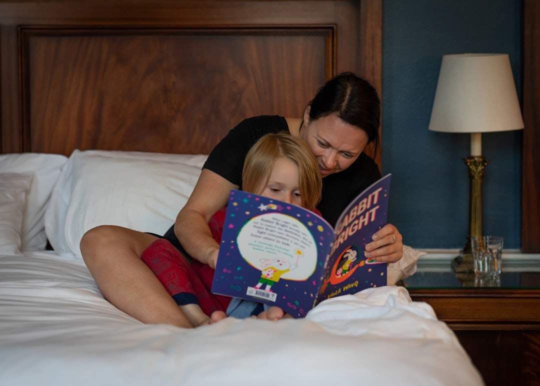 single mother reading bedtime story to child