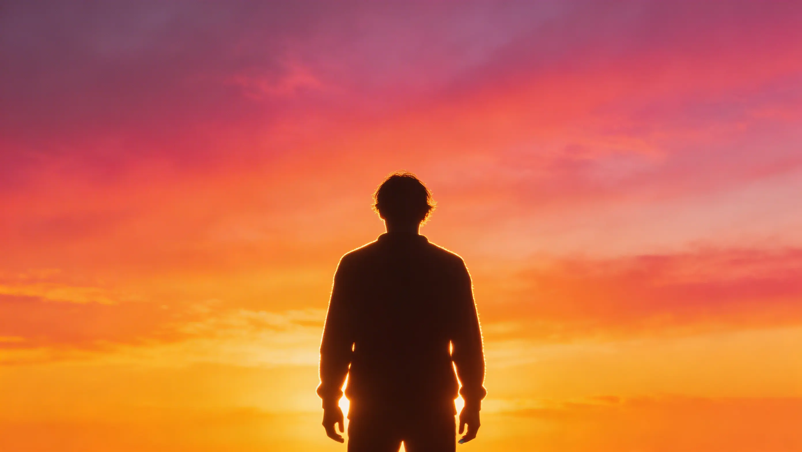 Person silhouette against bright backlit sunset