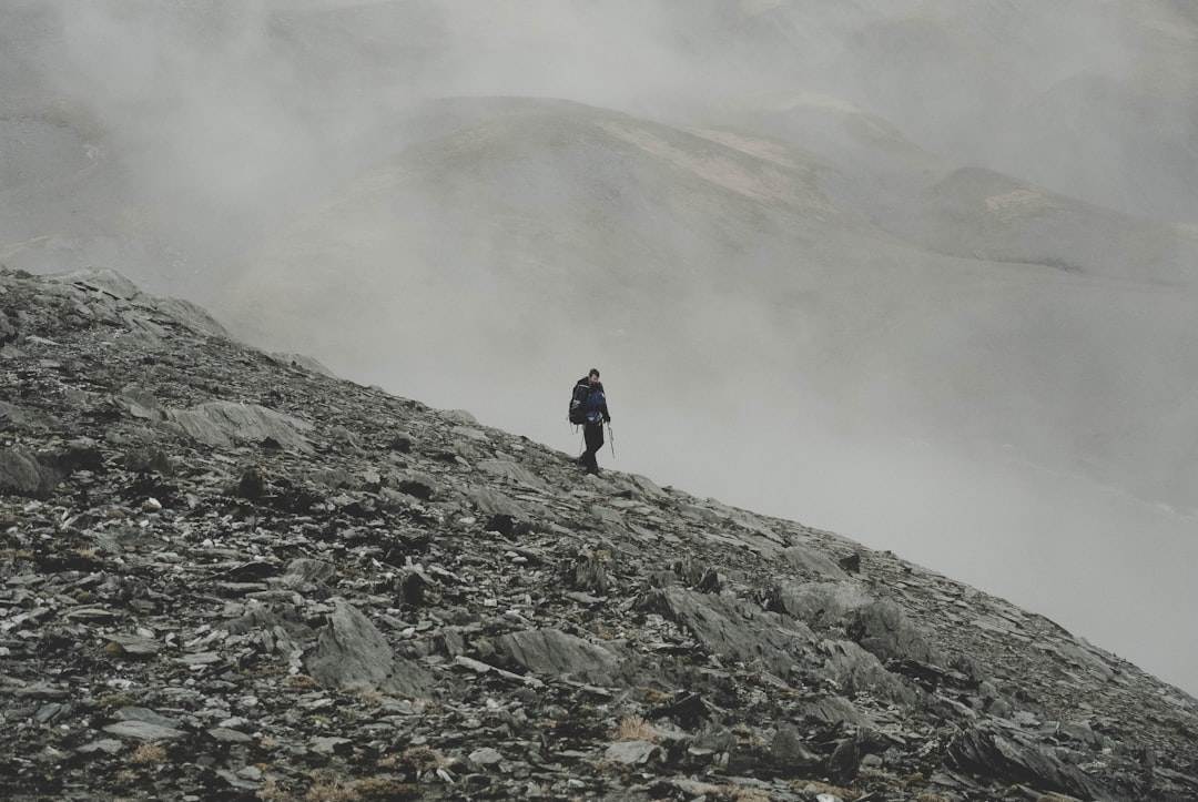 A person hiking in the mountains during the weekend