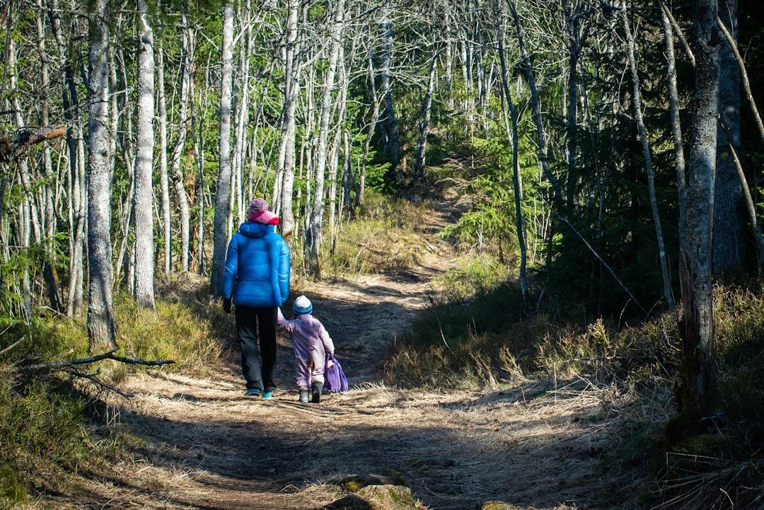 a mother and daughter hiking or engaging in an activity that suggests empowerment and mutual support
