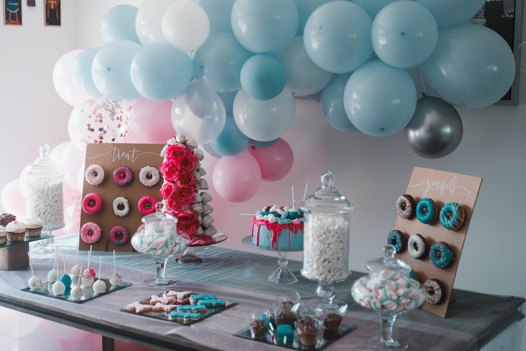 A festive birthday scene with a cake, balloons, and confetti.