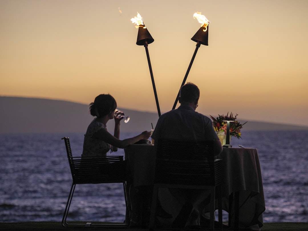 A romantic couple celebrating a birthday with a candlelit dinner.