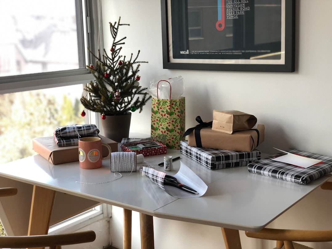Cozy Christmas crafting desk with paper trees, scissors, glue and twine